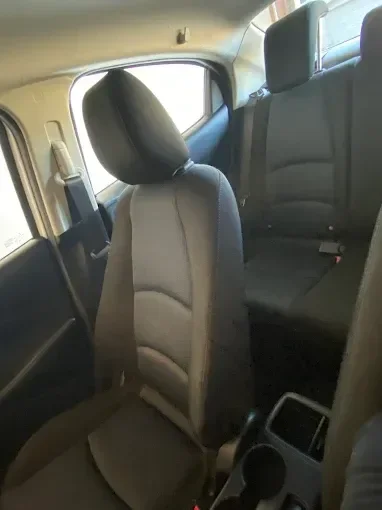 Interior view of vehicle showing gray and black upholstered front and rear seats
